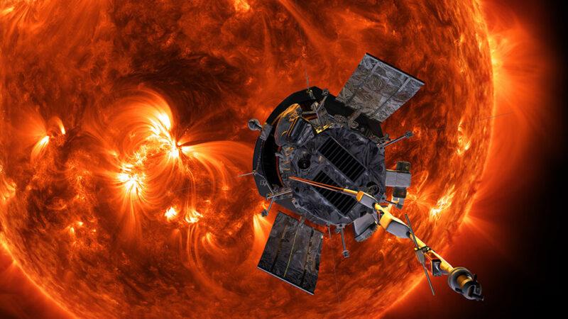An illustration shows the Parker Solar Probe approaching the orange sun. The metallic craft sports small instruments, two reflective sails and a long rod jutting out of one end.